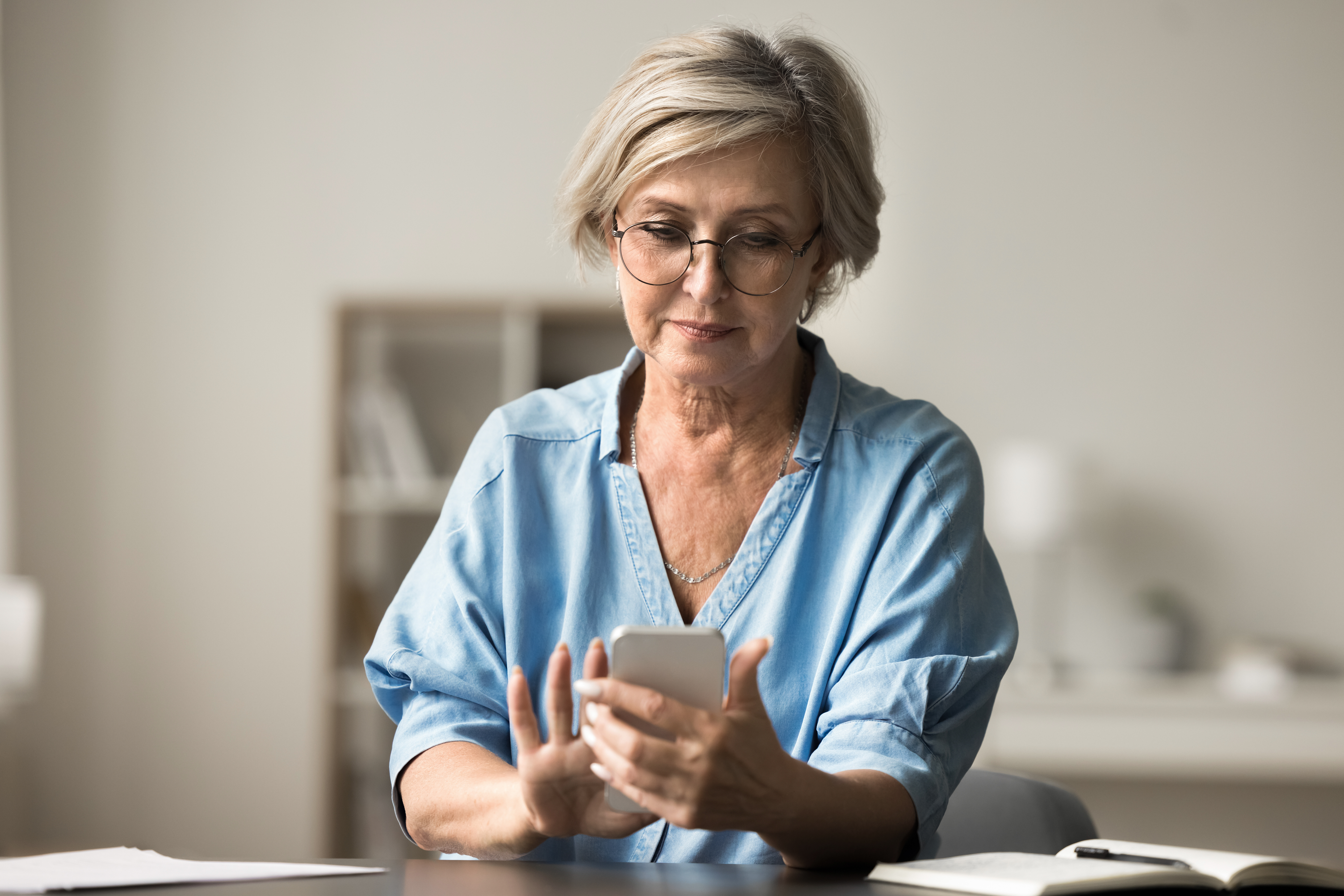 Carent accessing digital support services through her mobile phone